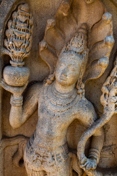 Ancient stone guardstone carving of a figure under a cobra hood, North Central Province, Anuradhapura, Sri Lanka