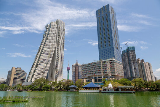 Altair tower and modern skyscrapers behind a lake with temple pavilions, Western Province, Colombo, Sri Lanka
