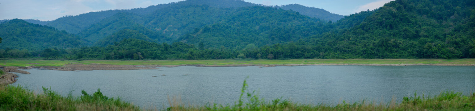 Serene Mountain Landscape with Calm Water and Lush Greenery