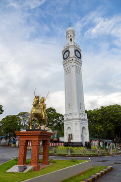 Clock tower beside a golden equestrian statue on a roundabout, Northern Province, Jaffna, Sri Lanka