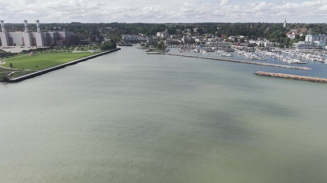 Port Washington, Wisconsin, United States - 23 September 2026: Aerial view of the harbor, marina, and industrial facility under construction along the lakeshore.