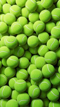 Close-up of bright green tennis balls tumbling and settling in dense fuzzy pile under soft even light, showing seams and felt texture from tight vertical viewpoint, vivid chartreuse repetition