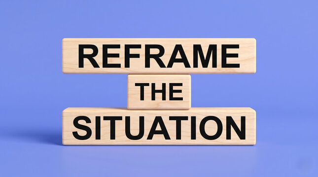 Wooden blocks featuring reframe the situation text displayed against a solid vibrant light blue backdrop surface. Concept of Reframe the Situation.
