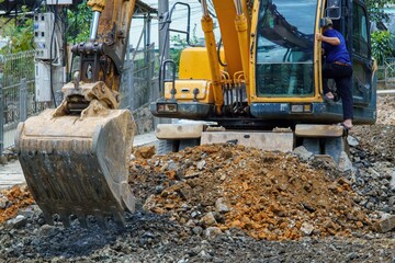 Worker beside an excavator cab in Da Lat Vietnam © IbragimovN