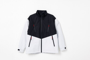 Black and white color block stand collar outdoor windbreaker jacket flat lay product shot on white background © jeson