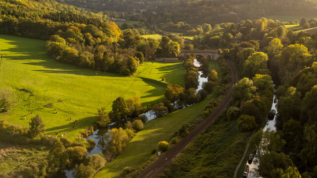 Aerial view of a lush countryside valley bathed in sunset light.