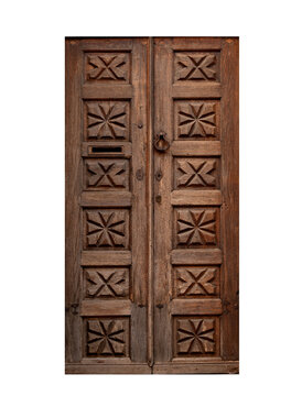 Traditional antique double wooden door featuring ornamental geometric star and diamond carvings, a vintage iron knocker, and mailbox slot. Cut out