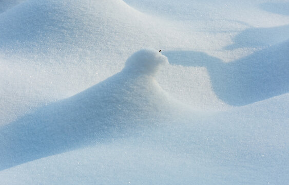 View of a small snow drift on a field in winter in Dwukoly, Warmian-Masurian Voiv, Poland.