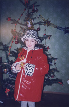 Retro Photo of a Girl in a Red Coat and Leopard Hat