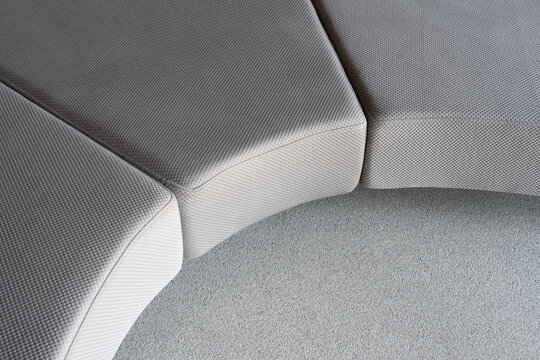 Curved modular sofa and textured carpet detail