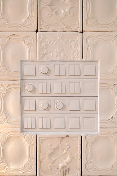 Modern light switches on vintage ceramic tile wall