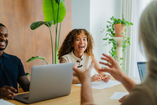 Businesswoman laughing during brainstorming session