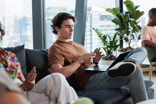 Young professionals work and relax in an office lounge.