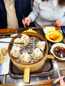 People eating dim sum dumplings