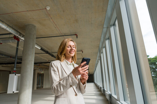 Businesswoman Using Phone At Construction Site