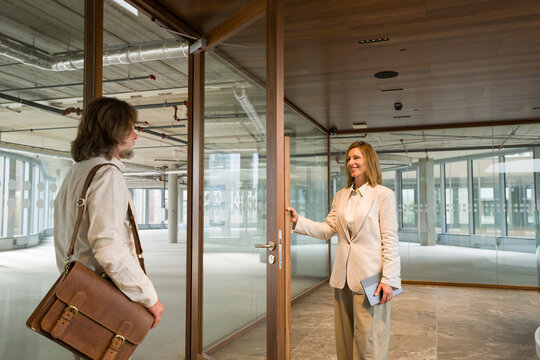 Real Estate Agent Shows Office Space to Customer