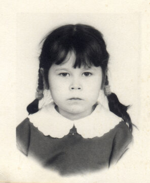 A young girl in braids and a lace collar, 1994