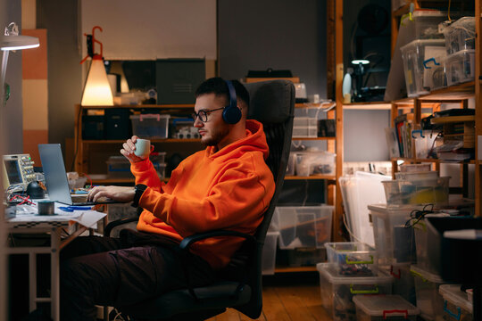 Young Developer Working Late in Home Electronics Workshop
