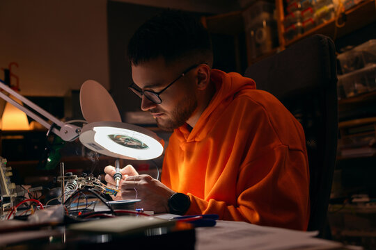 Electronics Student Soldering Circuit Board In Workshop