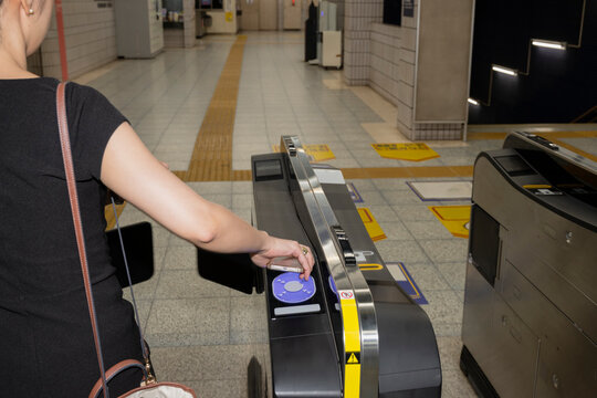 Woman Tapping Contactless Transit Gate