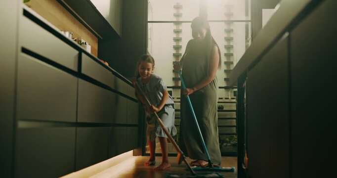Mom, cleaning and dancing with child in kitchen for music, fun chores or cleanliness in home. Mother, helpful daughter or kid sweeping floor with vibe or hygiene for dirt, germ or bacteria removal