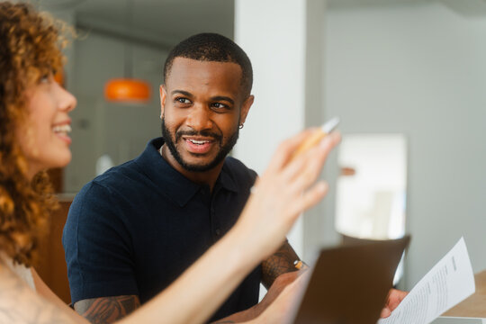 Colleagues conversing in office meeting