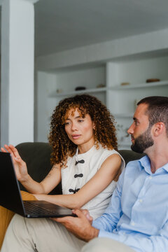 Female colleague explaining on laptop