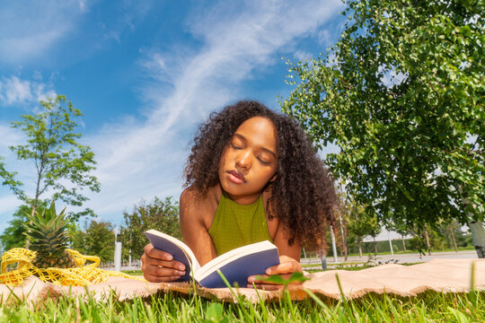 Shopper reading book outdoors on picnic blanket