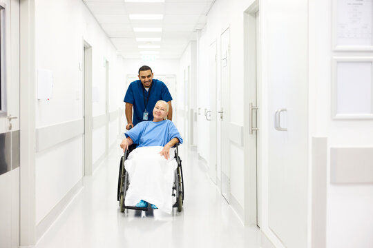 Orderly and patient in a wheelchair in the hospital corridor.