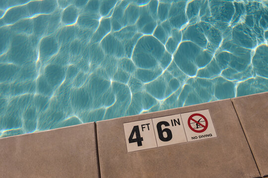 Swimming Pool Depth Sign Shows 4 ft 6in in Clear Water