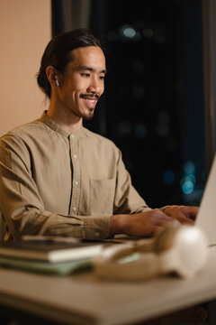 Man Working on Laptop in a Night Setting