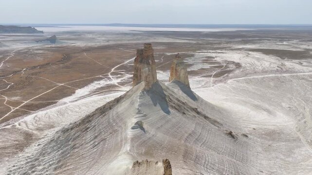 Aerial Pullback Revealing a Curved Layered Ridge Below the Bozzhyra Fangs