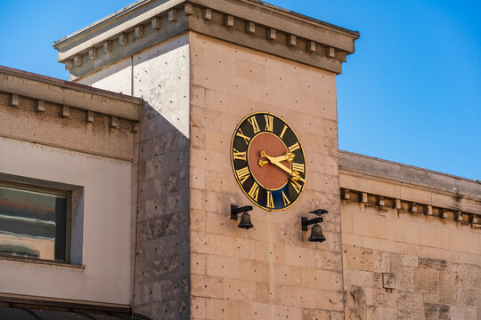 A large ornamental clock with golden Roman numerals adorns the pale stone facade of a historic building Tržnica Koper, the central market area in Koper, Slovenia