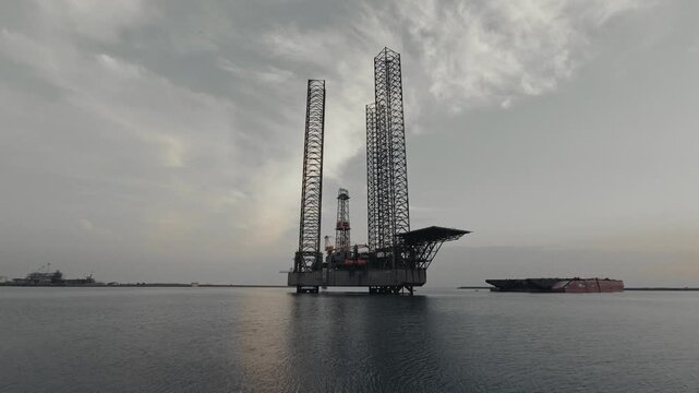 Wide view of an offshore drilling platform beneath a cloudy sky