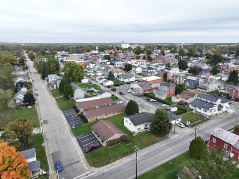 Aerial view of residential streets and houses in Tipp City, featuring autumn foliage, suburban architecture, and paved roads in Tipp City, Ohio, United States.