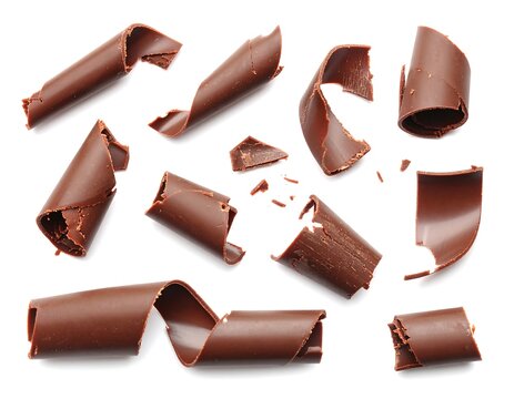 Chocolate curls scattered on a white background