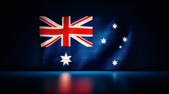Australian flag illuminated on a screen in a dark setting during a cultural event in Australia