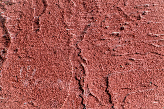 Macro Texture of Dark Red Rough Plaster with Deep Vertical Grooves and Trowel Marks