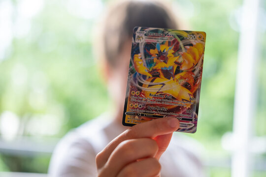 Child holding Pok&eacute;mon trading cards, focus on cards, Card Collection, Childhood Hobbies, youth culture and leisure, Gaming and Fan Entertainment, Battle with friends, Frankfurt - May 30, 2025