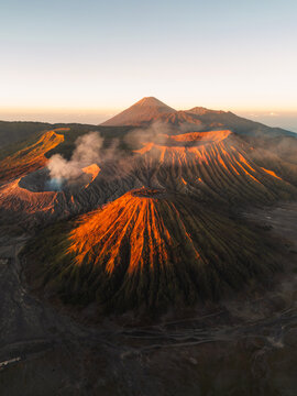 Golden Sunrise Illuminating Mount Batok with Smoking Mount Bromo and Mount Semeru in the Background, East Java, Indonesia