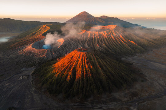 Golden Sunrise Illuminating Mount Batok with Smoking Mount Bromo and Mount Semeru in the Background, East Java, Indonesia