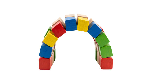 Colorful wooden blocks arch isolated on white, rainbow bridge made of toy building blocks, construction and balance concept with wood cubes