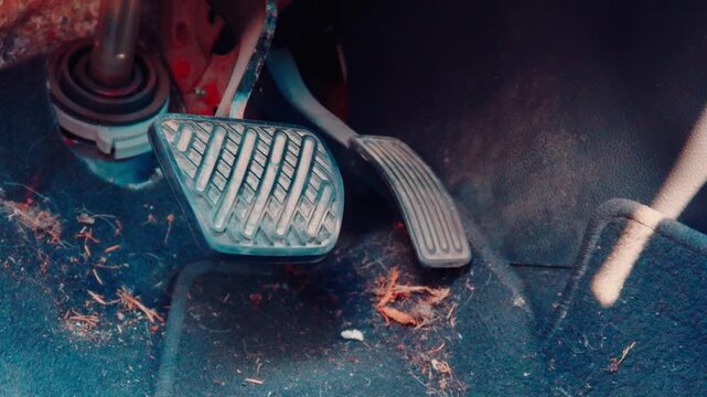 Dirty Car Foot Pedals and Dusty Carpet Floor Mat Close Up