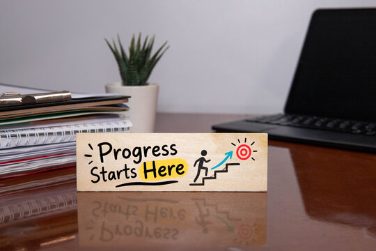 Progress Starts Here Personal Growth and Career Development Concept with Motivational Typography on Wooden Sign