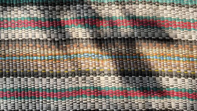 Straight horizontal lines of woven raffia string with subtle moving shadow, traditional interlaced polypropylene twine backdrop, 60fps 4K video