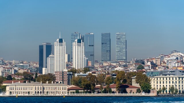 Istanbul skyline, Turkey, with modern skyscrapers rising behind historic waterfront buildings and trees on the European shore of the Bosphorus