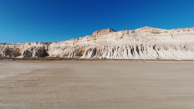 Ground-Level Travel Past Deeply Fluted White Cliffs at Tuzbair