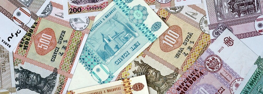 Moldovan leu money bills in pile on table. Moldova MDL currency banknotes background