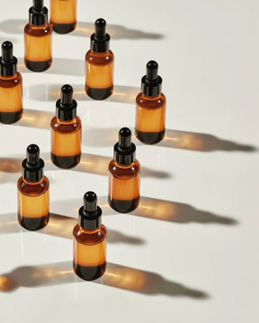 Amber Glass Dropper Bottles Arranged on Minimal Light Background