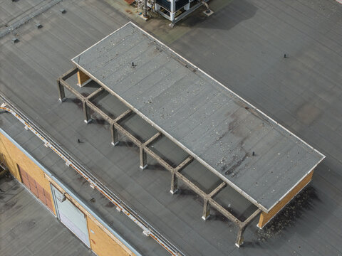 Aerial view of the industrial roof structure at Bayswater North Factories, featuring a flat grey roof, metal support beams, and ventilation units in Melbourne, Victoria, Australia.